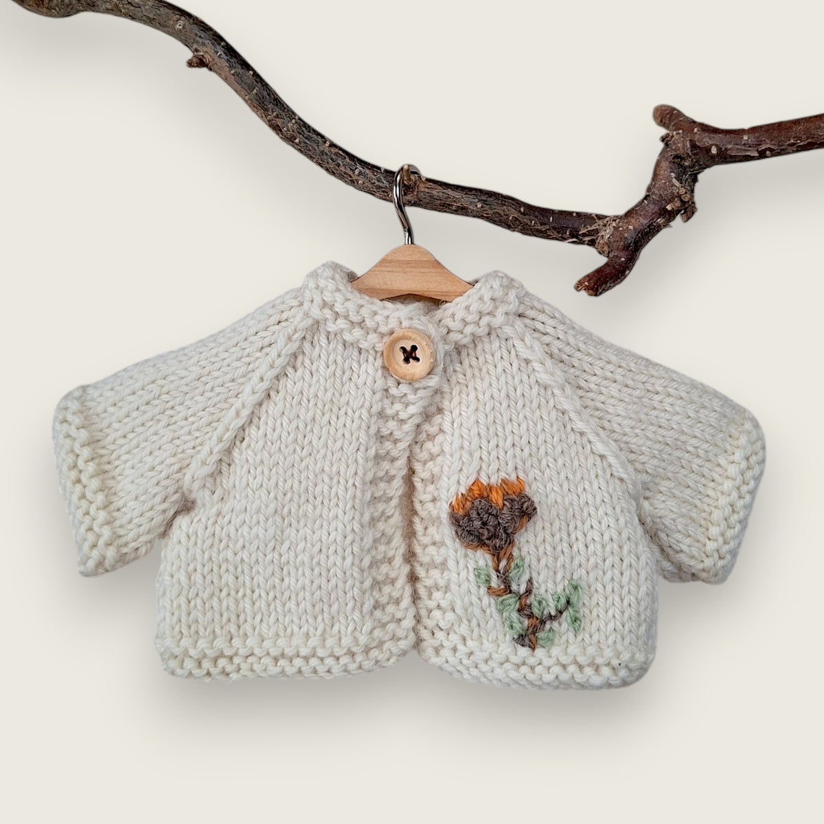 Ecru wool cardigan with hand-embroidered thistle flower and leaves