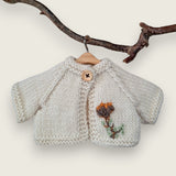 Ecru wool cardigan with hand-embroidered thistle flower and leaves