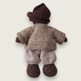 Rear view of fawn wool bear cardigan with hand-embroidered bee shown on Pebblewood Resident