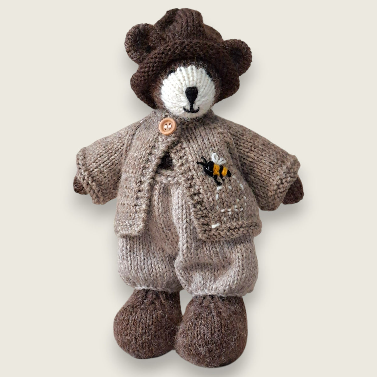 Pebblewood Resident wearing fawn wool cardigan with hand-embroidered bee