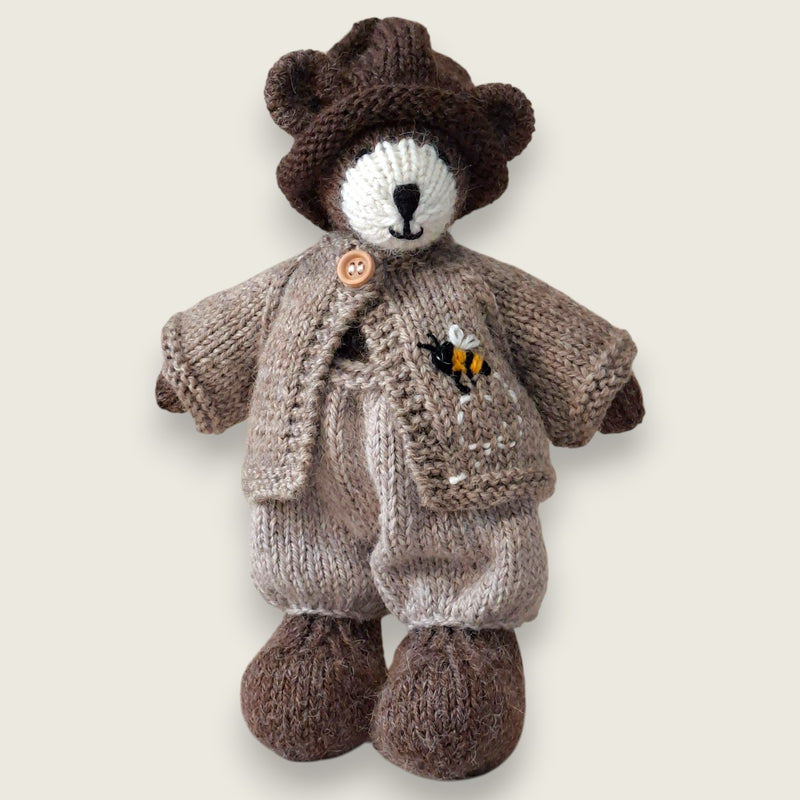 Pebblewood Resident wearing fawn wool cardigan with hand-embroidered bee