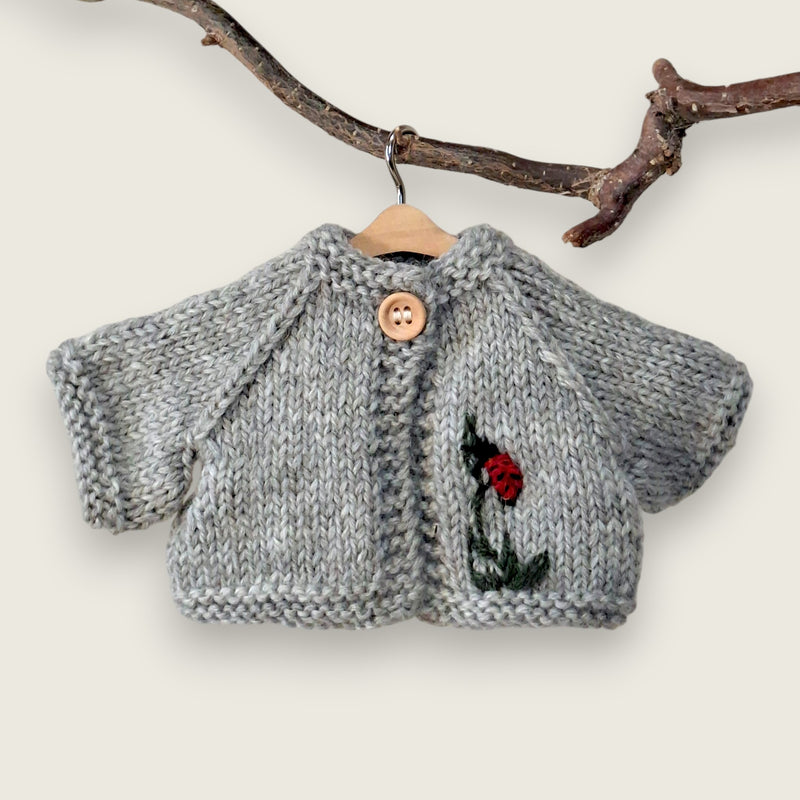 Light grey wool cardigan with hand-embroidered ladybird and leaf detail