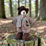 Pebblewood Resident wearing light grey ladybird cardigan in woodland setting