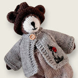 Pebblewood Resident wearing light grey wool cardigan with embroidered ladybird