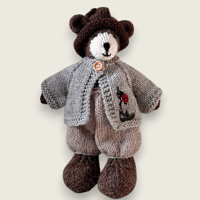 Pebblewood Resident wearing light grey wool cardigan with embroidered ladybird