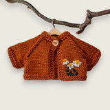 Rust wool cardigan for Pebblewood Residents with hand embroidered daisies