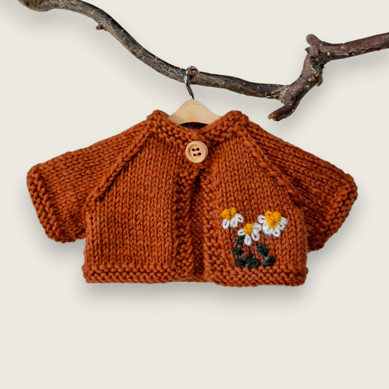 Rust wool cardigan for Pebblewood Residents with hand embroidered daisies