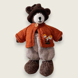 Pebblewood Resident wearing rust wool cardigan with hand embroidered daisies