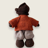 Rear view of rust wool cardigan for Pebblewood Residents with hand embroidered daisies