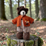 Pebblewood Resident wearing rust wool daisy cardigan in a woodland setting