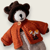 Pebblewood Resident wearing rust wool cardigan with embroidered daisies