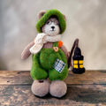Pip Elder, the first Pebblewood bear and Elder Resident, displayed with his green dungarees, round glasses, knitted hat, scarf and needle-felted lantern.