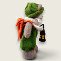Right side view of Pip Elder, Pebblewood Elder Resident, showing his hand-knitted clothing, round glasses and needle-felted lantern.