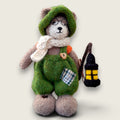 Pip Elder, hand-knitted Pebblewood collectible bear and Elder Resident, wearing green dungarees, glasses, knitted hat and scarf, carrying his handmade felted lantern.