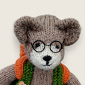Close-up of Pip Elder showing hand-finished facial features and spectacles.