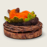 Rear view of the fox curled among the wet felted merino leaves