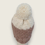Back view of the fawn and natural hat, showing the textured stitch and pompom