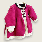 Angled view of magenta merino wool baby matinee coat