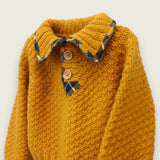 Angled view of mustard children's jumper with printed tartan trim.