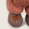 Close-up of Swallow Flight's needle-felted heart on the right paw.