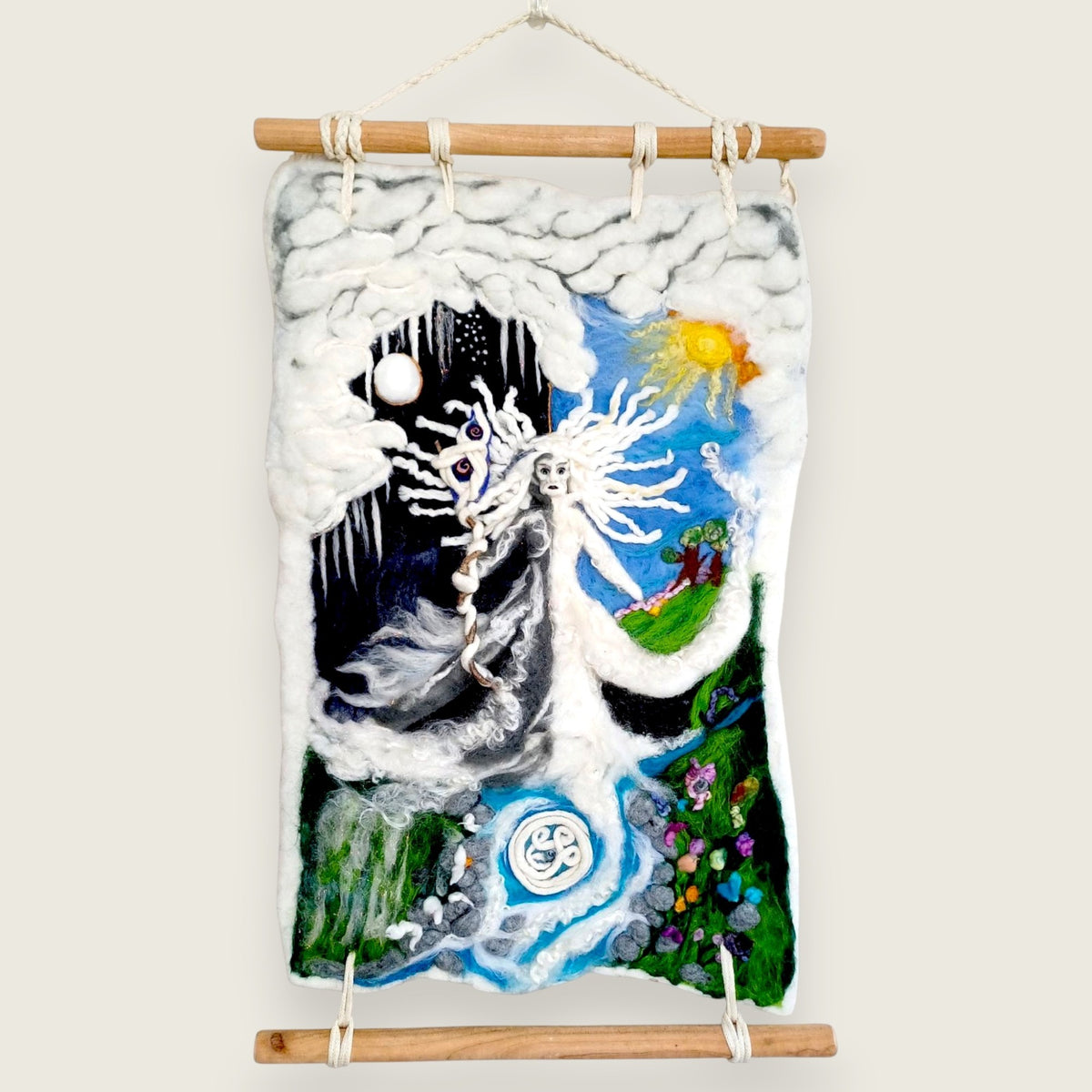 Needle felted wall hanging of the Cailleach between winter and spring