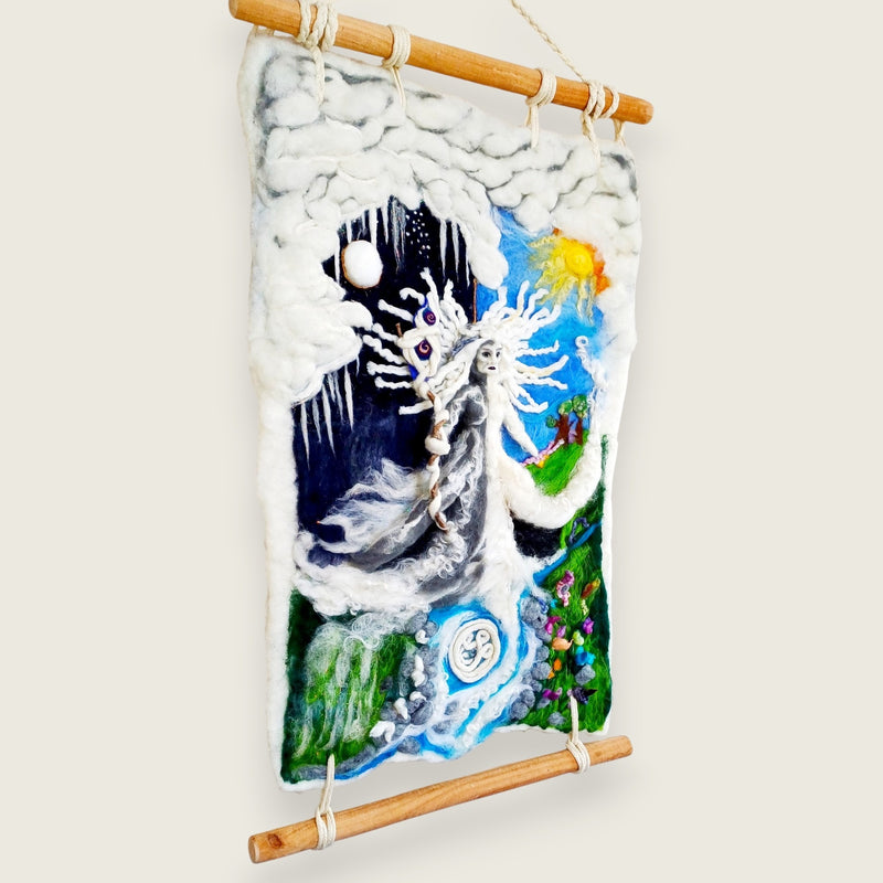 The felted wall hanging seen from the side on its wooden poles