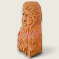 Left side view of The Woodlander hand-carved lime wood sculpture, showing the depth of the face and textured hair and beard carving.