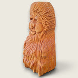 Left side view of The Woodlander hand-carved lime wood sculpture, showing the depth of the face and textured hair and beard carving.