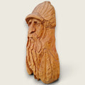 Left side view of The Woodsman hand-carved lime wood sculpture, showing the carved face, beard, cap and feather detailing.