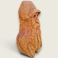 Right side view of The Woodsman hand-carved lime wood sculpture, showing the depth of the facial, beard and feather carving.