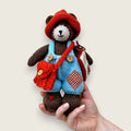 Thorne Ash handmade Pebblewood collectible bear held in a hand to show his scale and size.