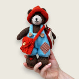 Thorne Ash handmade Pebblewood collectible bear held in a hand to show his scale and size.