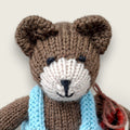 Close-up of Thorne Ash showing the individually finished face of the hand-knitted Pebblewood collectible bear.
