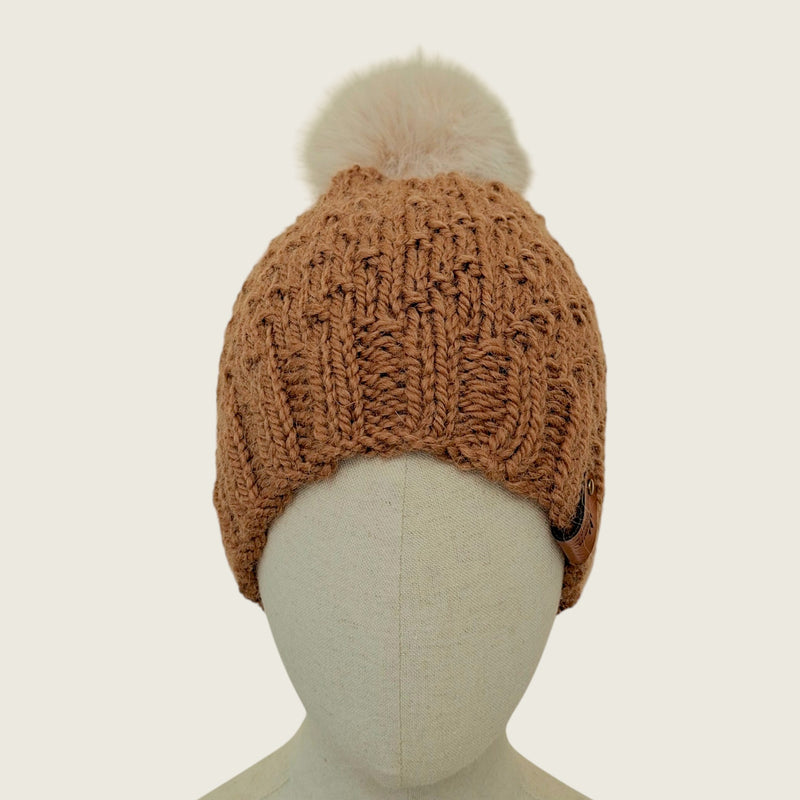 Toffee handknitted alpaca and wool hat with a mink-coloured faux fur pompom, front view
