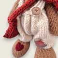 Needle-felted rust-red heart on the right paw of Willow Hearth, a Permanent Resident of Pebblewood.