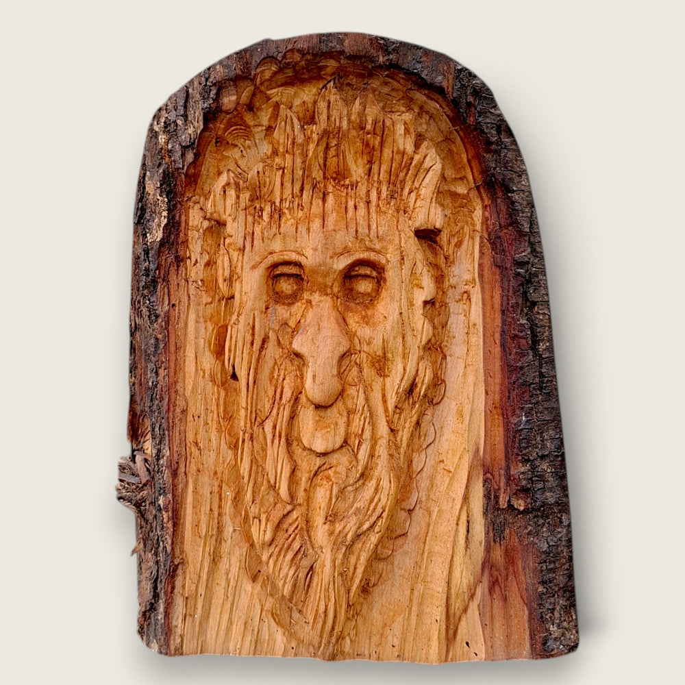 Hand-carved woodland face wood sculpture with natural bark edge, handcrafted in the Boyne Valley, Ireland.